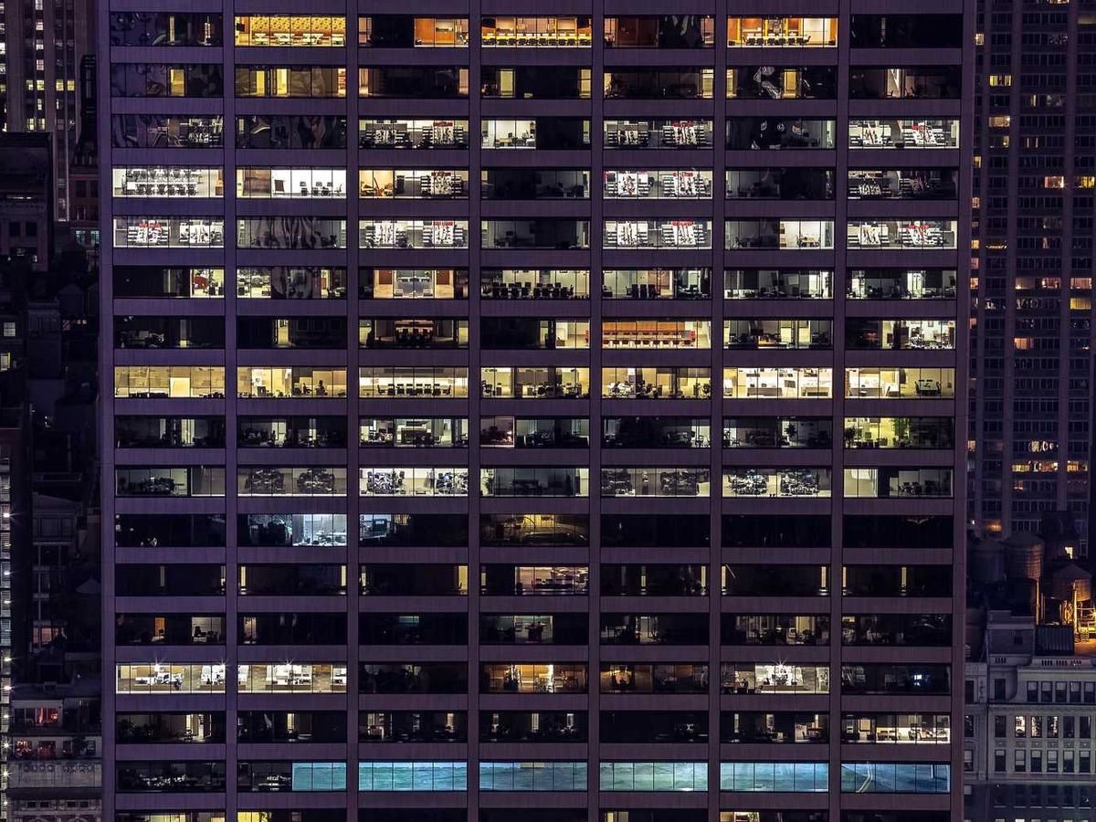 A nighttime view of a high-rise office building in Panama City, with illuminated windows showcasing the vibrant urban landscape.