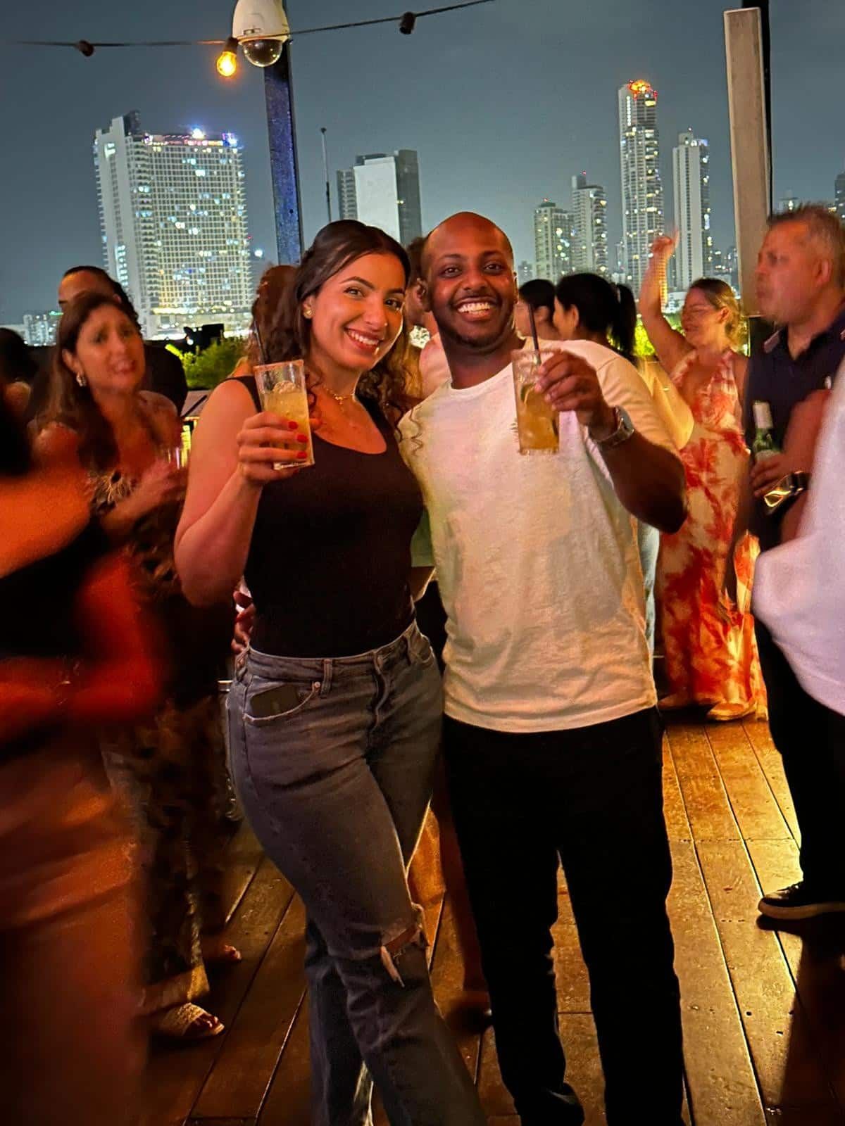 Couple enjoying cocktails at a rooftop bar in Panama City during a nighttime adventure tour