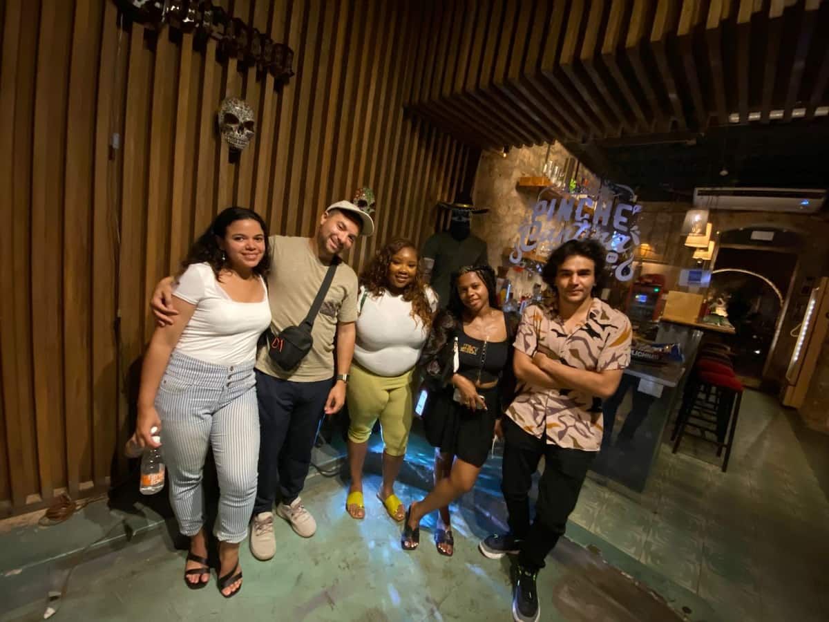Group of friends enjoying a night out at a bar during the Casco Viejo Nightlife Bar Crawl in Panama City, Panama.