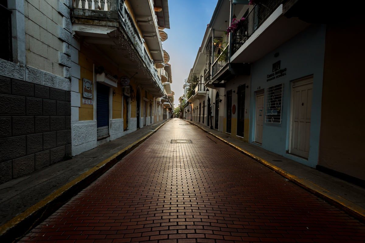 A picturesque cobblestone street in Casco Viejo, Panama City, showcasing colorful colonial architecture and serene morning light.