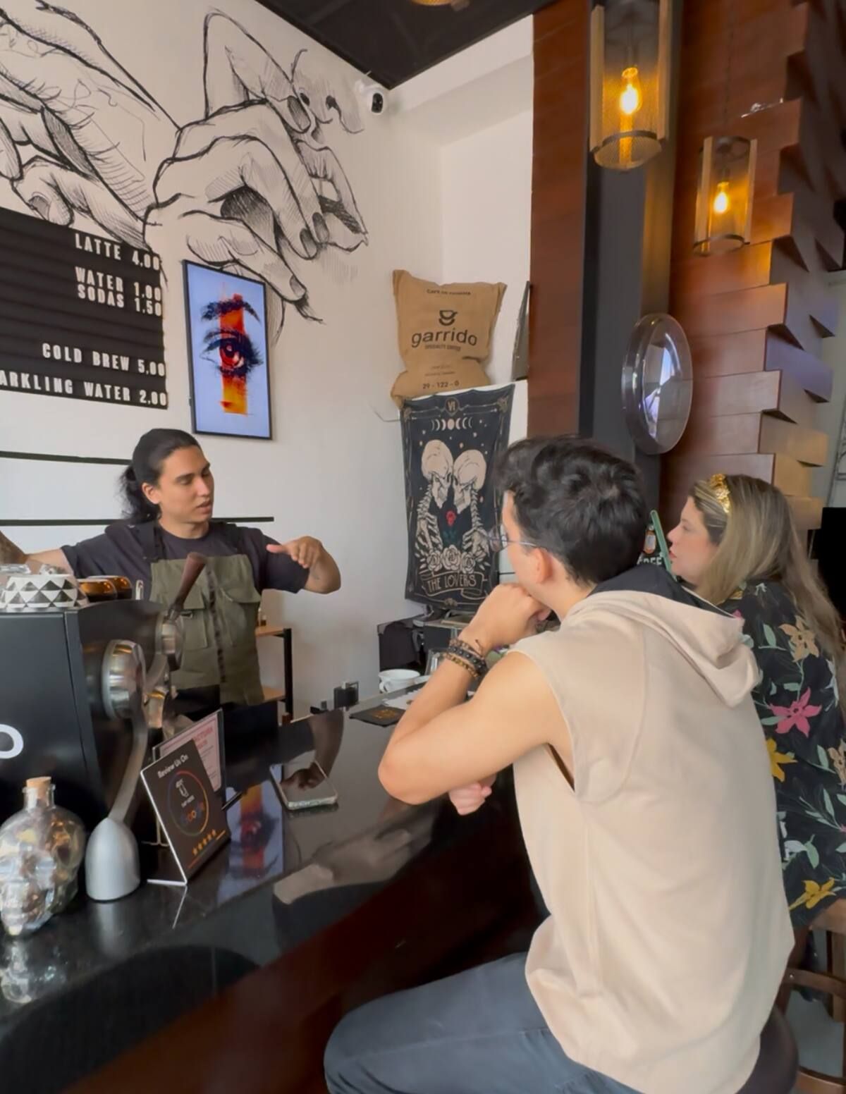 Barista serving customers at a coffee shop during a Geisha Coffee Tasting tour in Casco Viejo, Panama City