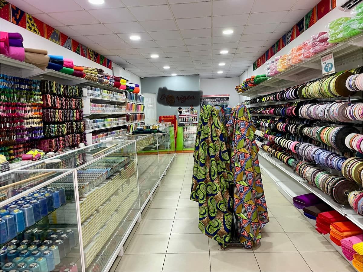 Colorful fabrics and sewing supplies displayed in a vibrant store aisle during the Guna Culture Urban Tour in Casco Viejo, Panama