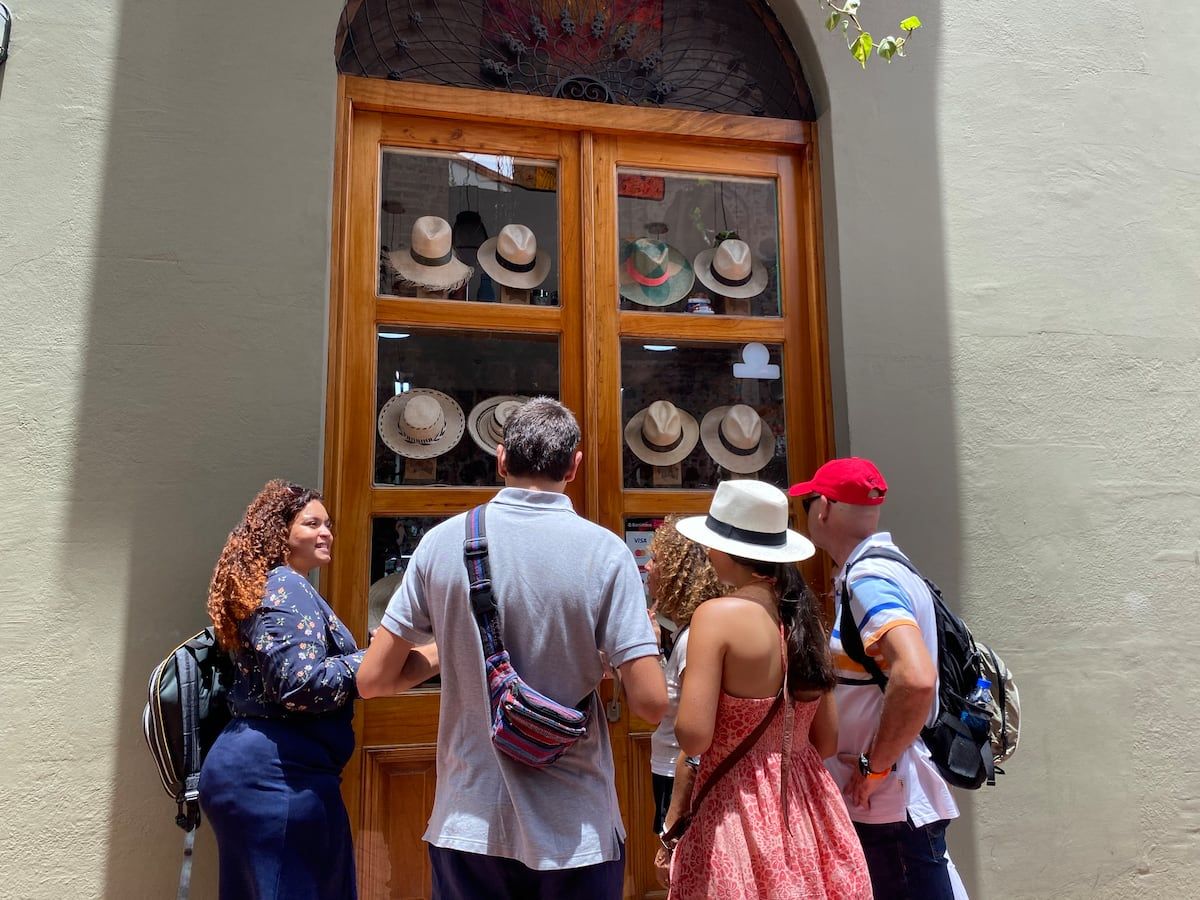 Tourists examine a display of traditional panama hats at a historic shop in Casco Viejo, Panama City.