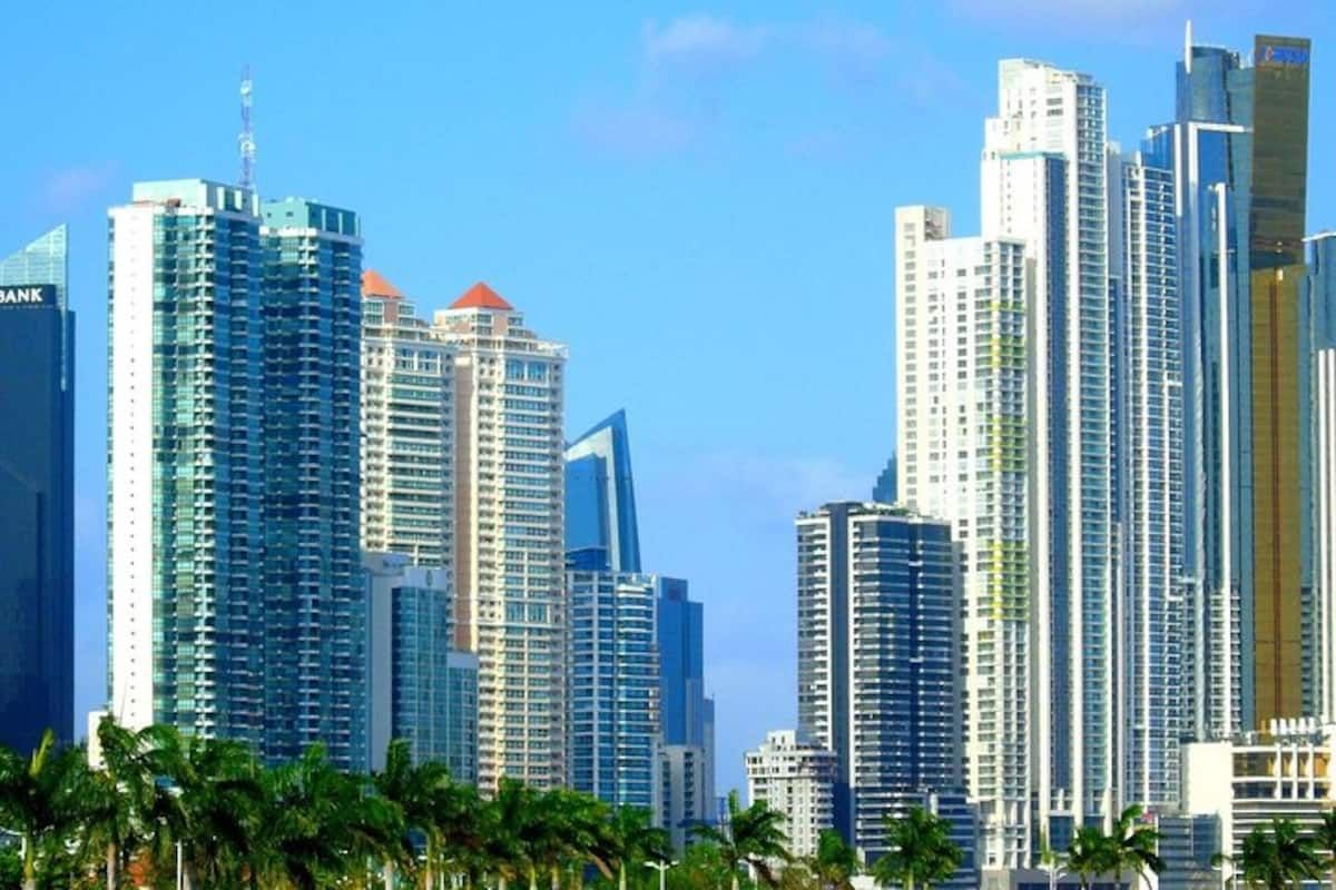 Panama City skyline with modern skyscrapers and palm trees under a clear blue sky during a Panama Canal tour by Bandits Adventure Tours Panama