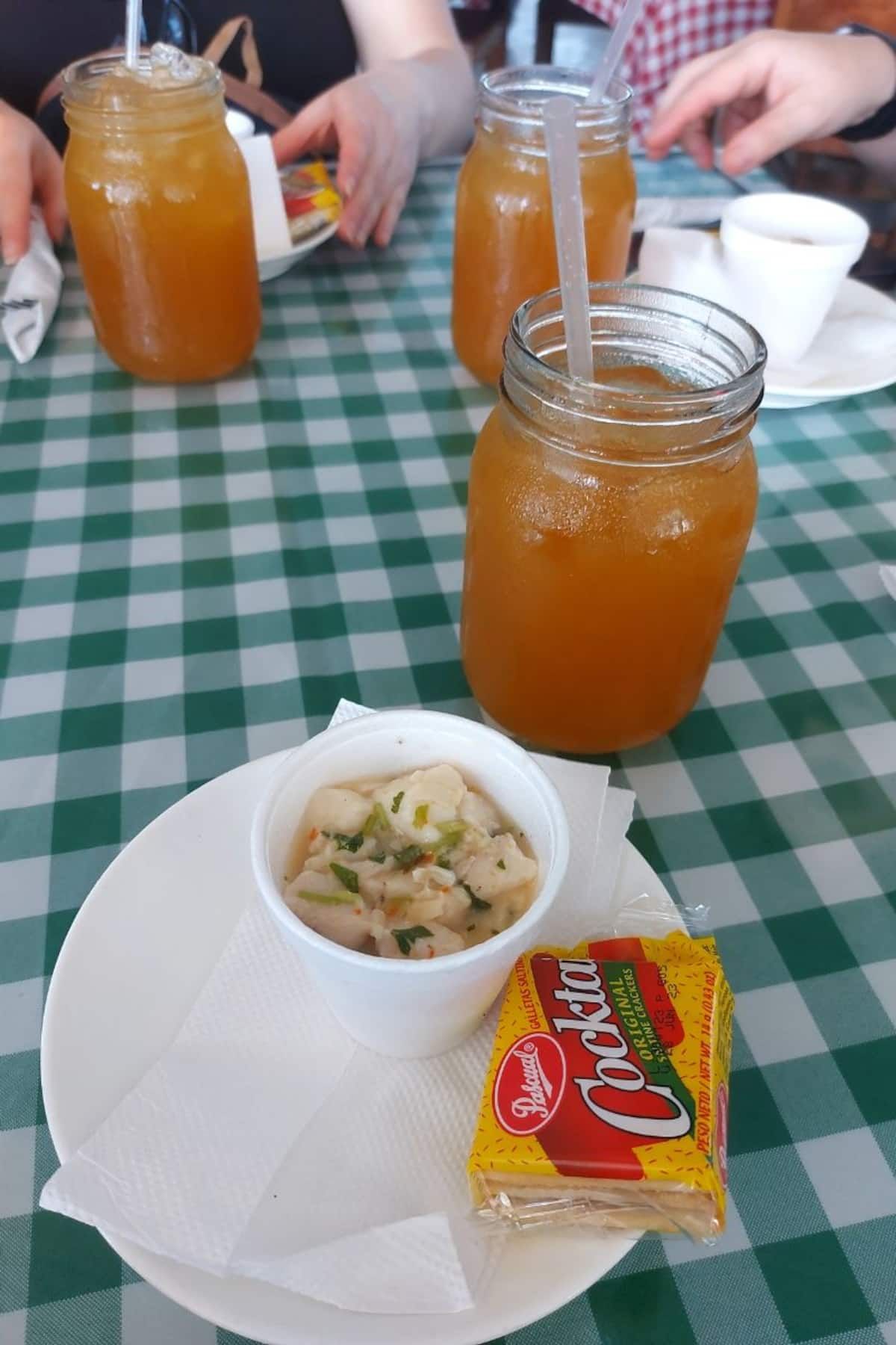 A traditional Panamanian meal with ceviche and iced tea served at a local market in Panama City, showcasing the vibrant food culture of the region.