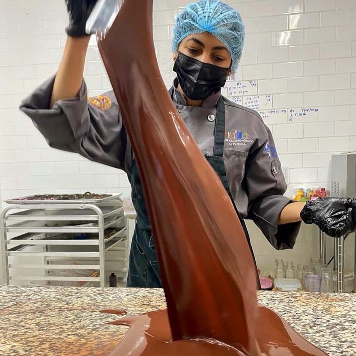 Chef pouring melted chocolate during a Panamanian Chocolate Bean To Bar Tasting experience in Panama City, Panama.