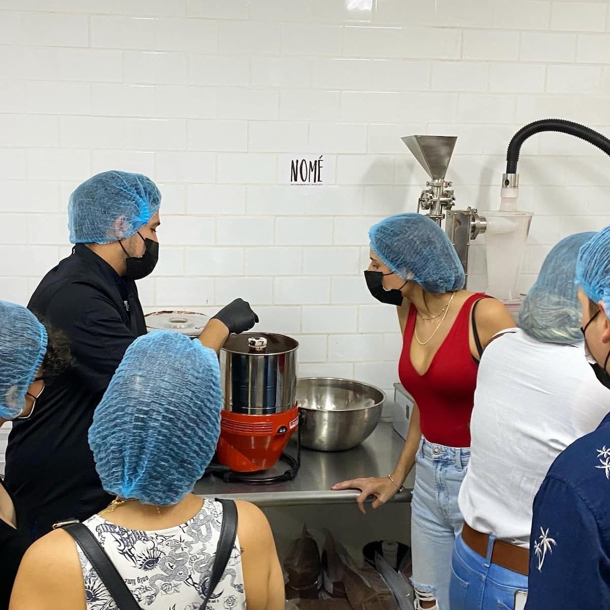 Participants learn the chocolate-making process during a Panamanian Chocolate Bean To Bar Tasting workshop in Panama City, guided by a chef.