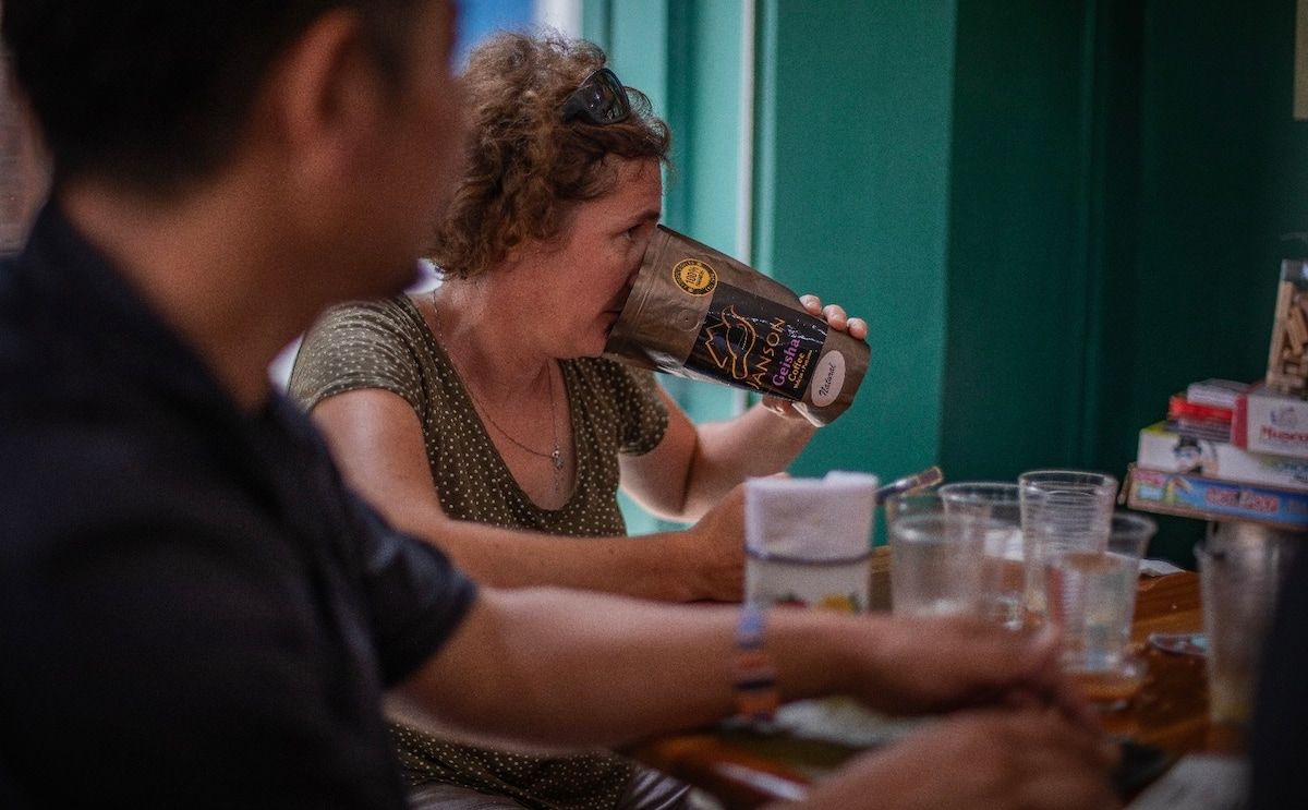 Woman sipping coffee during a Panamanian coffee tasting experience in Casco Viejo, Panama City, with Bandits Adventure Tours Panama.