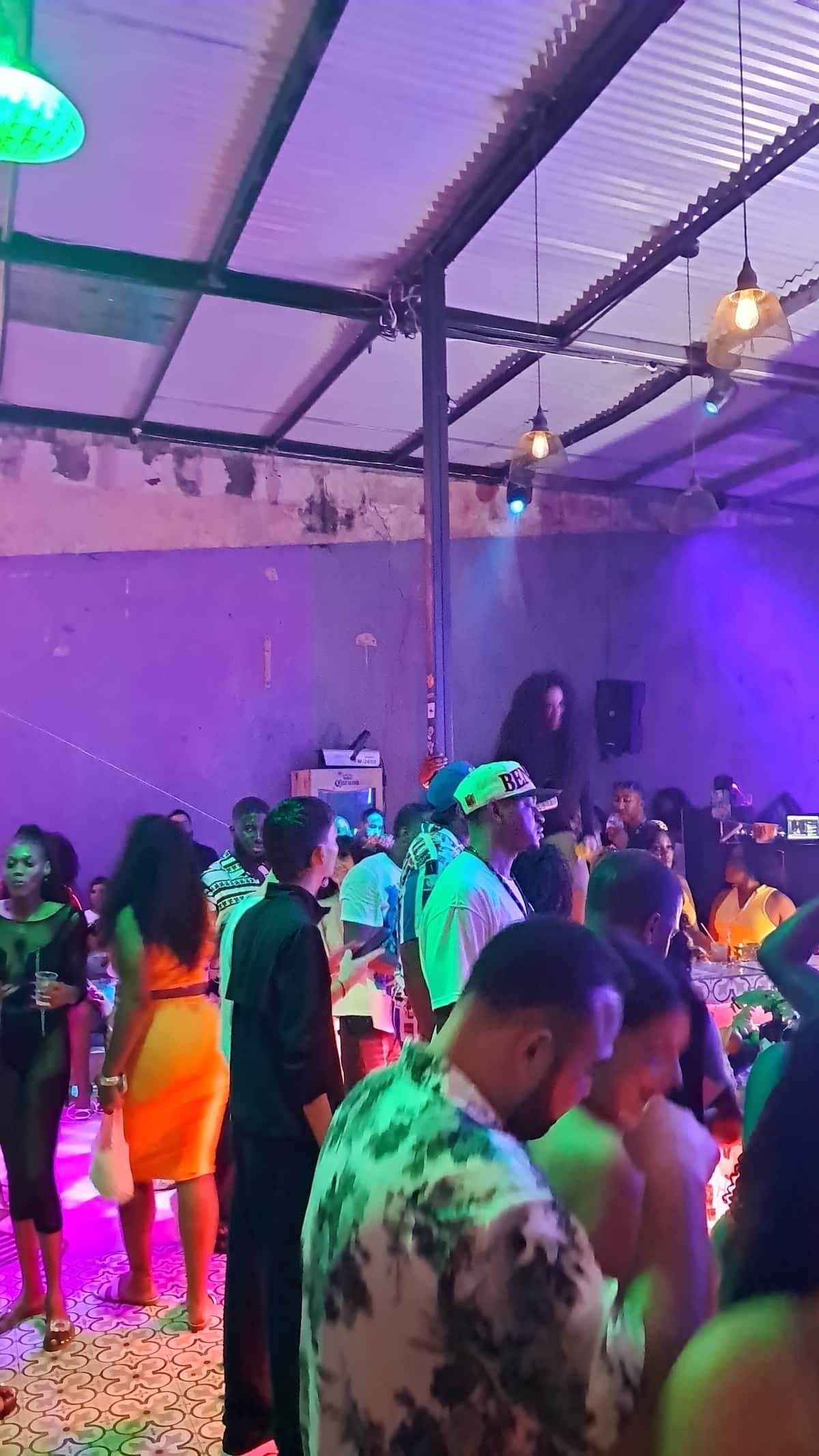 Crowd enjoying a lively Rumba party in Casco Viejo, Panama City, with colorful lighting and energetic atmosphere.