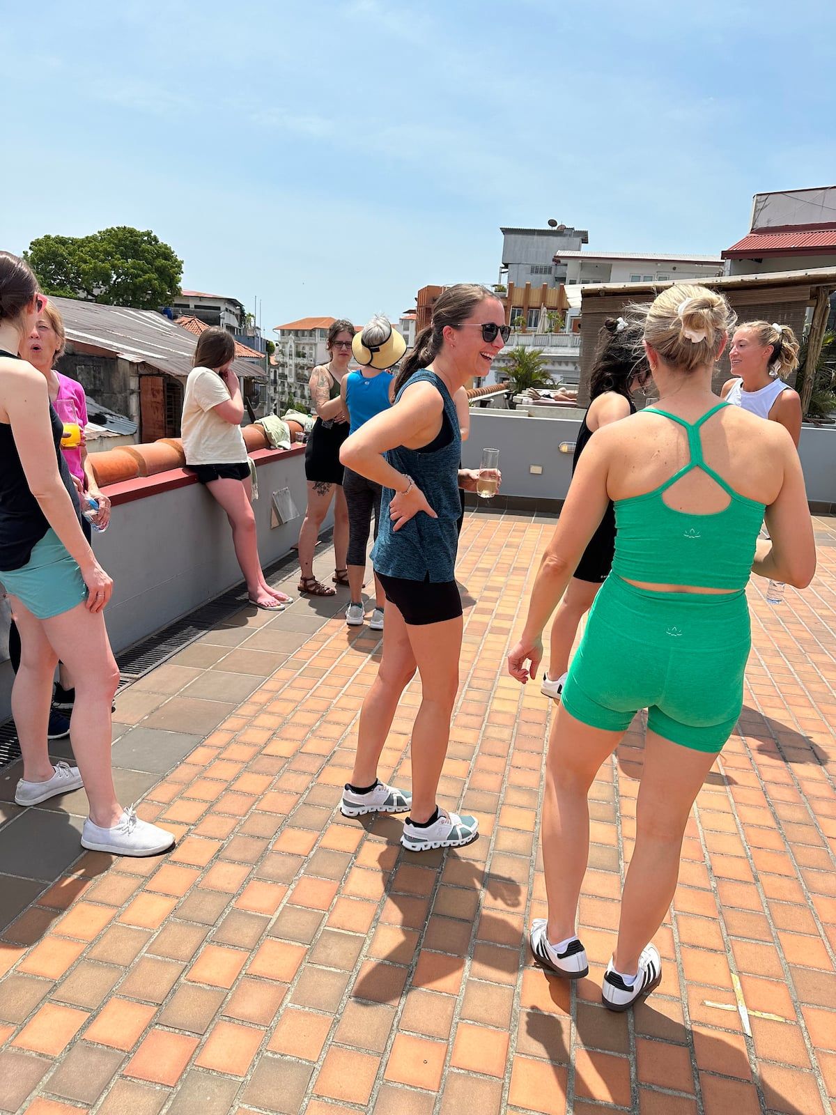 Women enjoying a social gathering on a rooftop terrace during the Serene Yoga Experience in Casco Viejo, Panama City.