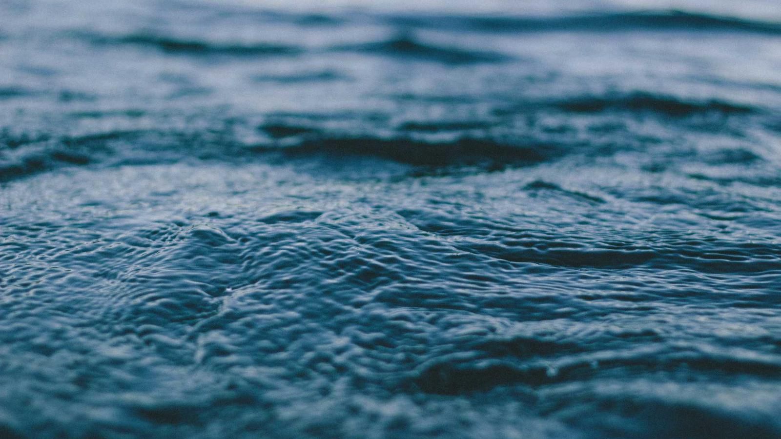 Close-up of rippling water during a sunset sailing cruise in Panama City, showcasing the serene ocean surface and gentle waves.