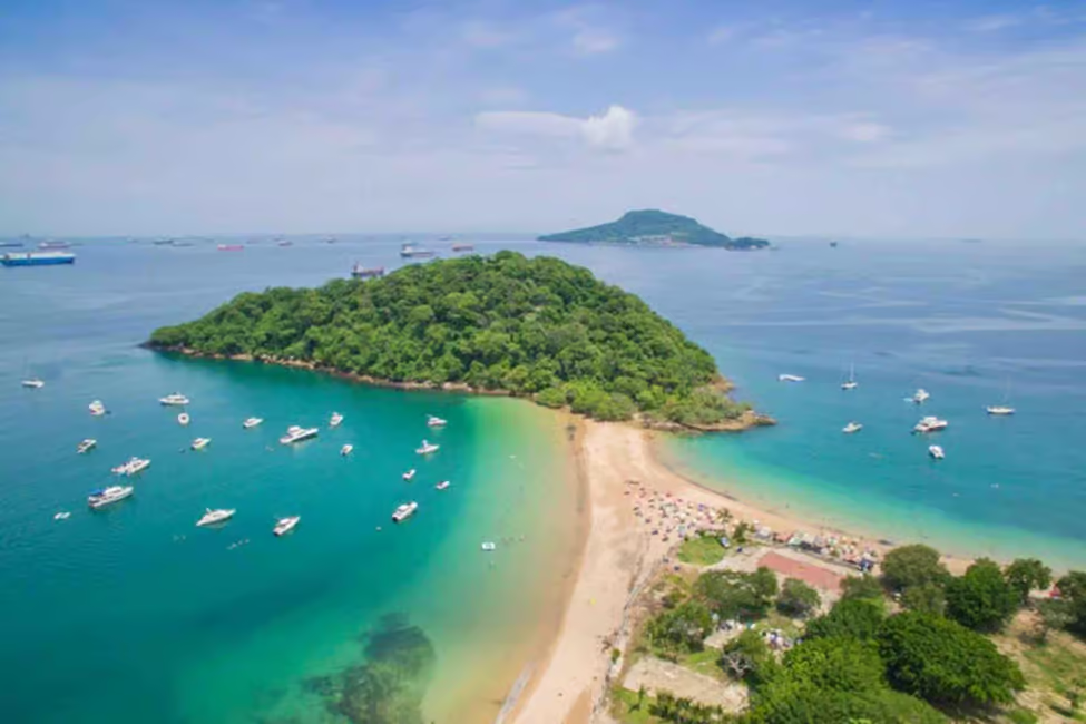Aerial view of Taboga Island beach with turquoise waters, anchored boats, and lush greenery, offering a perfect day trip from Panama City.