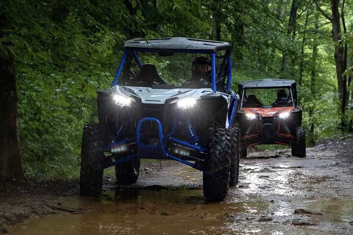 ATVs navigating a muddy jungle trail during an adventurous tour in Panama City, Panama.